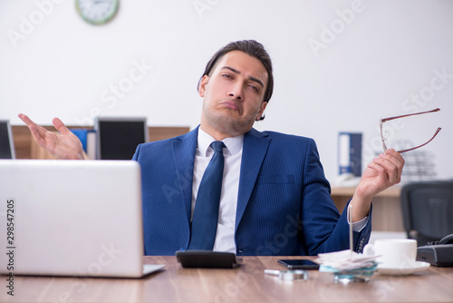 Young male businessman working in the office