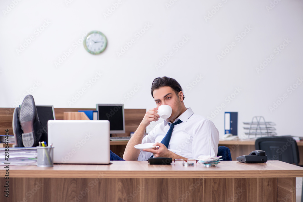 Young male businessman working in the office Young male businessman working in the office