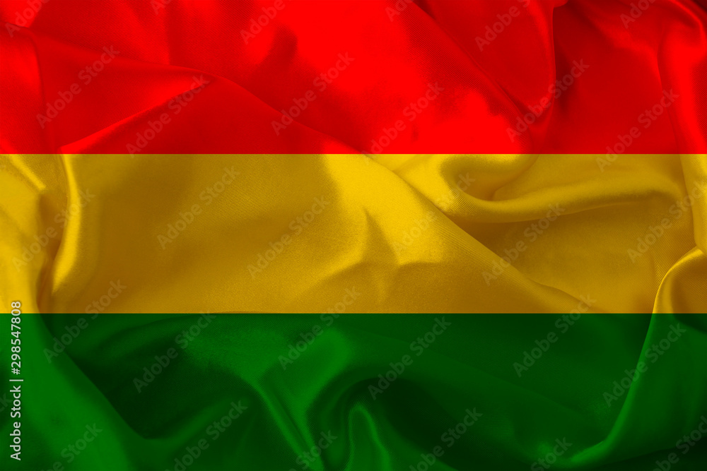 beautiful photo of a colored national flag of the modern state of Bolivia on a textured fabric, concept of tourism, emigration, economy and politics, close up beautiful photo of a colored national flag of the modern state of Bolivia on a textured fabric, concept of tourism, emigration, economy and politics, close up
