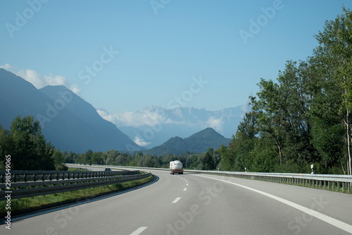 Car driving on road in Germany, with mountains on both side of the highway