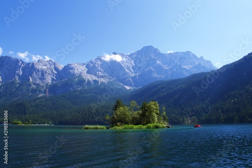 View of Mountains, forrest, and small island in Lake