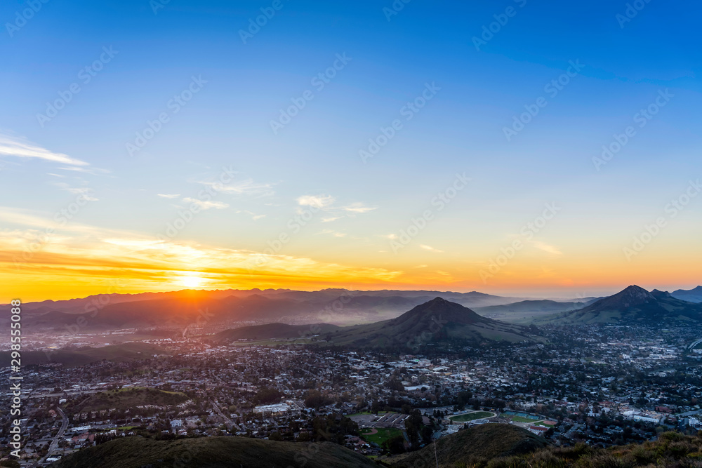 Setting Sun over Hills, Mountain Peaks, City
