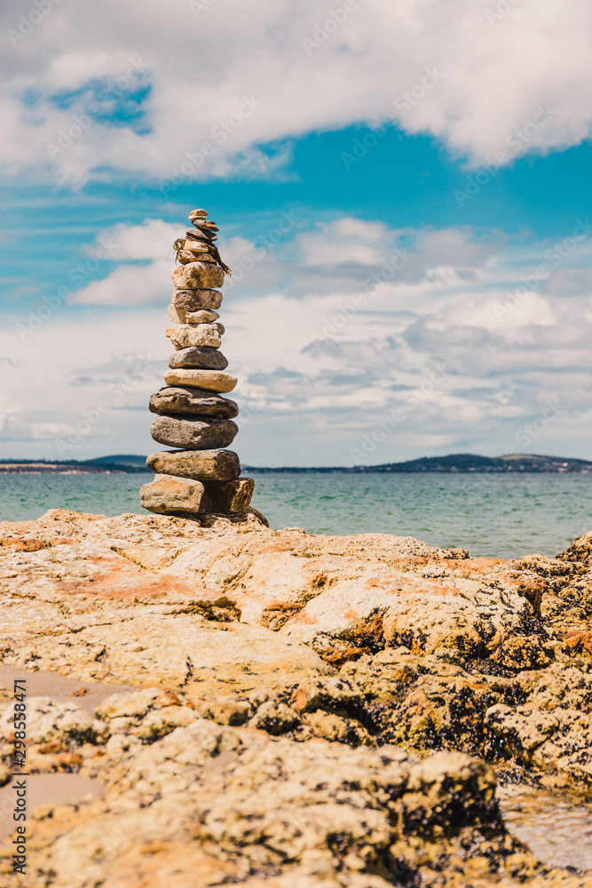 pebbles and rocks in relaxing zen inspiring stack on the beach in Australia pebbles and rocks in relaxing zen inspiring stack on the beach in Australia