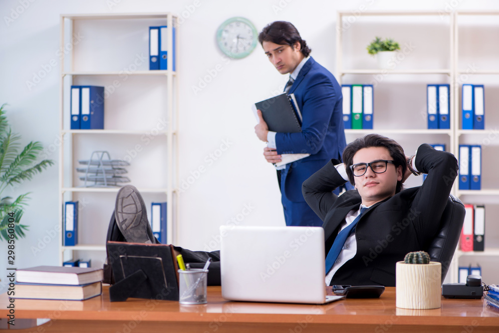 Boss and his male assistant working in the office