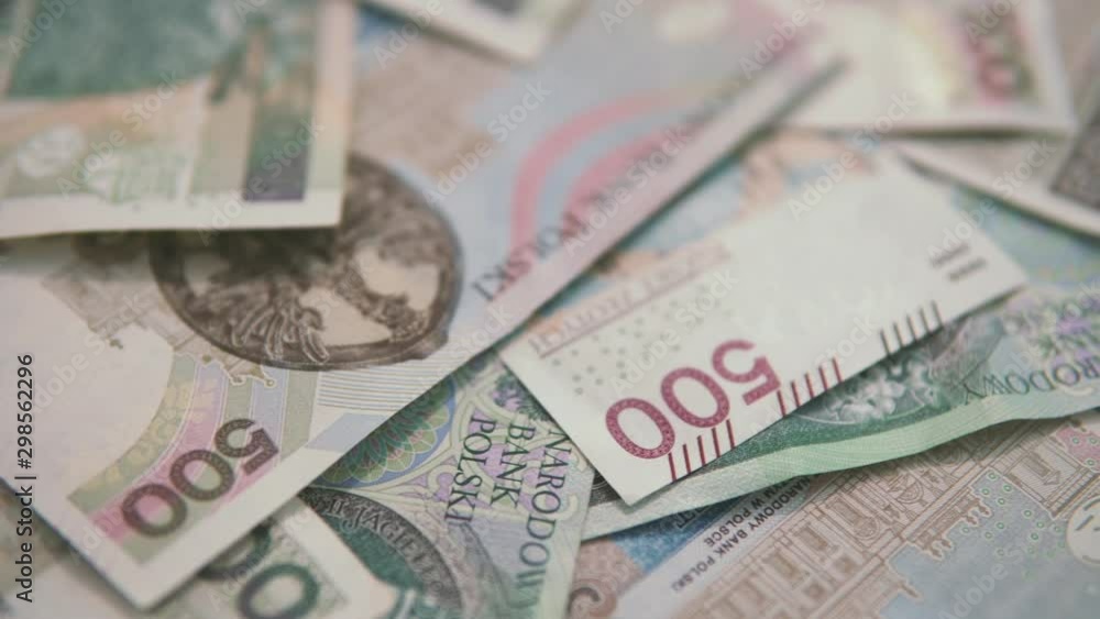 Panning: scattered polish money, 500 and 100 zlotys banknotes are lying side by side Panning: scattered polish money, 500 and 100 zlotys banknotes are lying side by side