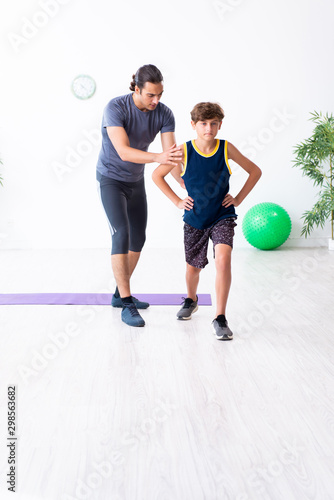 Young father and his son doing exercises