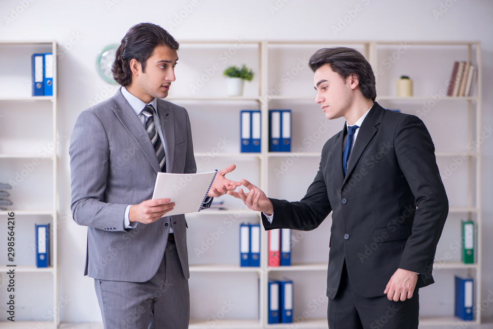 Two young businessmen meeting in the office
