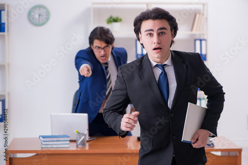 Boss and his male assistant working in the office