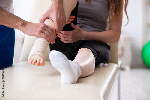 Leg injured woman visiting young doctor traumatologist