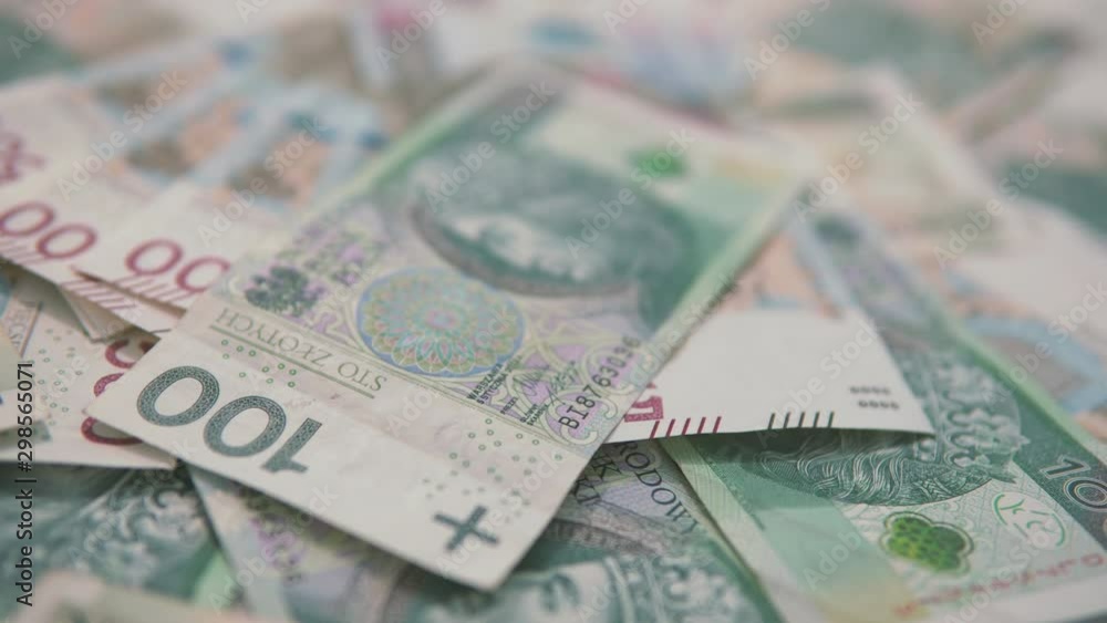 Panning: from left to right close up polish banknotes 100 PLN on foreground, 500 zloty in the background Panning: from left to right close up polish banknotes 100 PLN on foreground, 500 zloty in the background