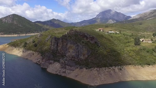 Camporredondo reservoir with the espigüete mountain in the background aerial shot photo