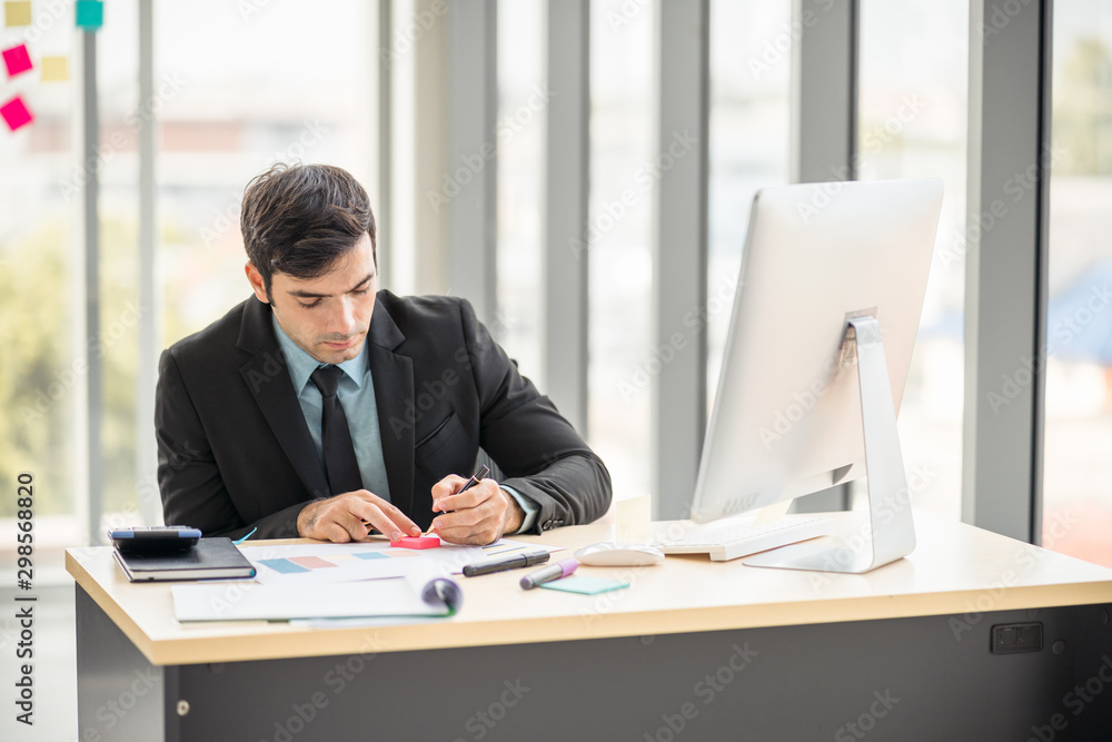Businessman working in office with desktop computer and documents on his desk with copy space using as background professional business people, successful business man consultant concept. Businessman working in office with desktop computer and documents on his desk with copy space using as background professional business people, successful business man consultant concept.
