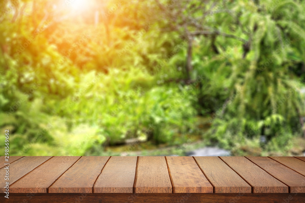 Empty wood table top on blur abstract green from garden background. Empty wood table top on blur abstract green from garden background.