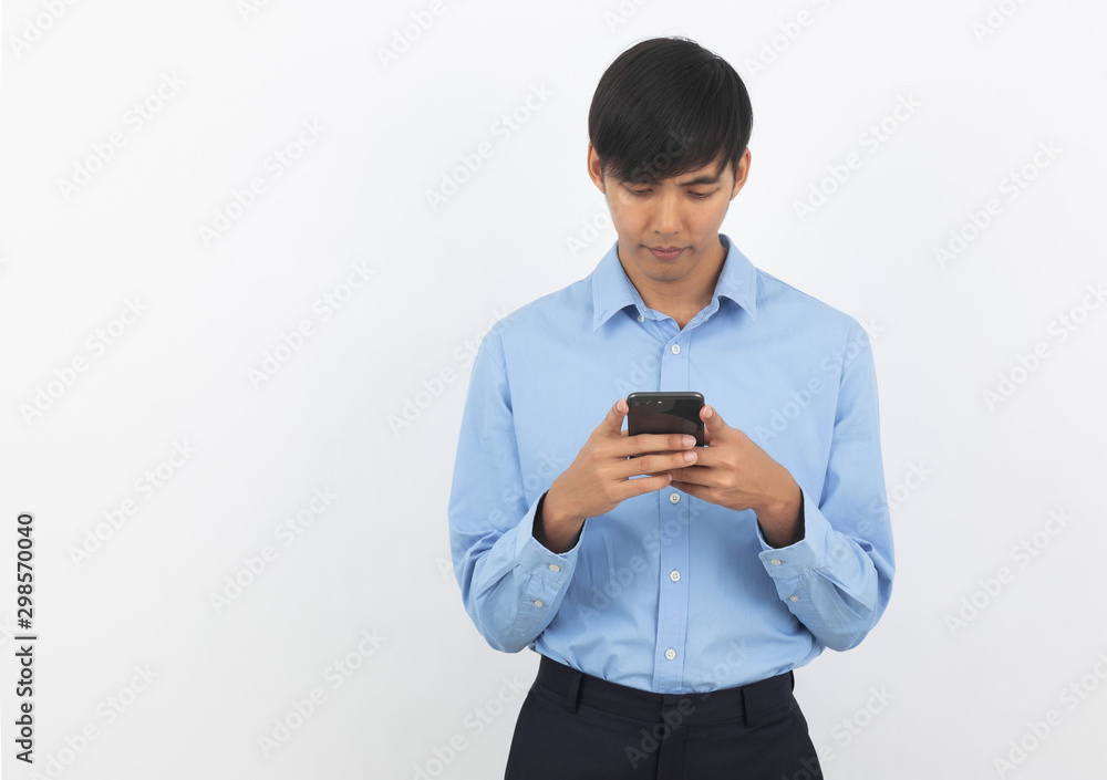 Young handsome asian business man playing smartphone with thinking an idea isolated on white background. Young handsome asian business man playing smartphone with thinking an idea isolated on white background.