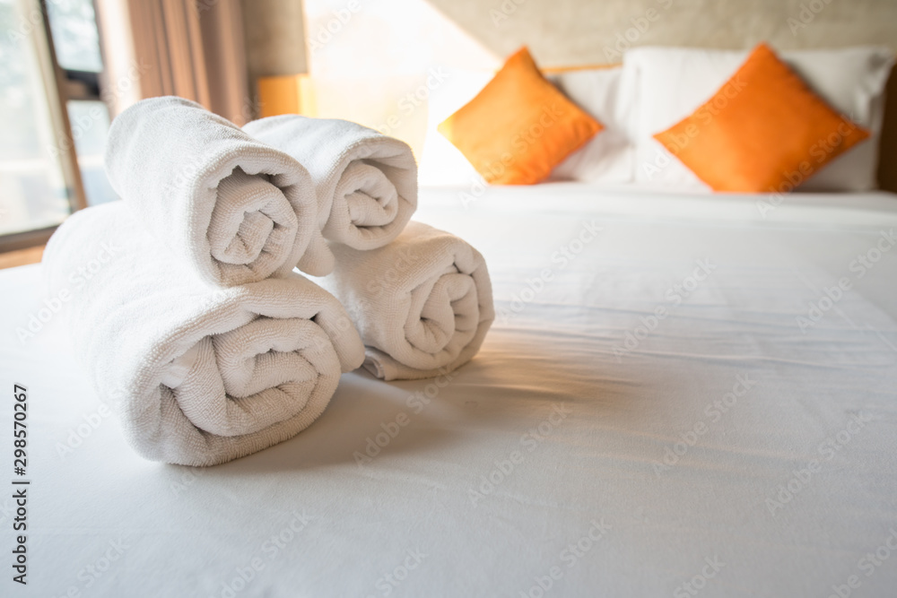 Set of towel on the bed in hotel bedroom. Conceptual of hotel amenities. - obrazy, fototapety, plakaty 