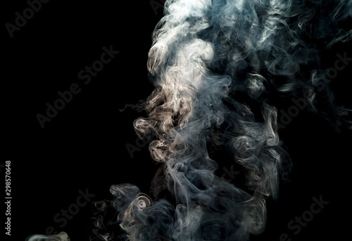Blurred of white smoke movement over dark background for your abstract design.