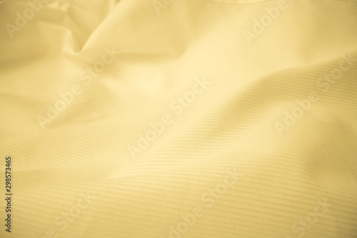 Shiny flowing cloth texture in macro shot. Wavy clean silk weave material. Textile abstract background. photo