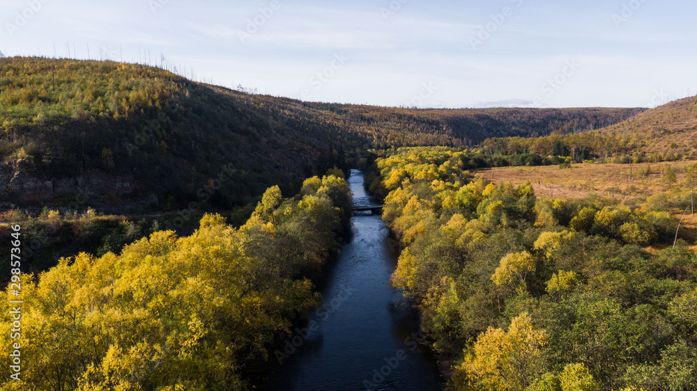 Naklejka premium Top view of the taiga forest, river, road . The vast expanses of Eastern Siberia. far East Russia