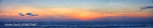 Phuket beach sunset, colorful cloudy twilight sky reflecting on the sand gazing at the Indian Ocean, Thailand, Asia.