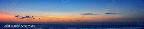 Phuket beach sunset, colorful cloudy twilight sky reflecting on the sand gazing at the Indian Ocean, Thailand, Asia. © Jeremy