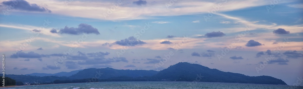 Phuket beach sunset, colorful cloudy twilight sky reflecting on the sand gazing at the Indian Ocean, Thailand, Asia. Phuket beach sunset, colorful cloudy twilight sky reflecting on the sand gazing at the Indian Ocean, Thailand, Asia.