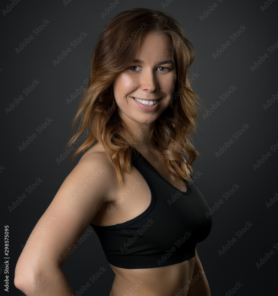 Pretty slim fitness trainer posing in studio Pretty slim fitness trainer posing in studio