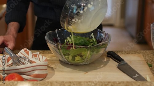 Making salad dressing and tossing salad photo