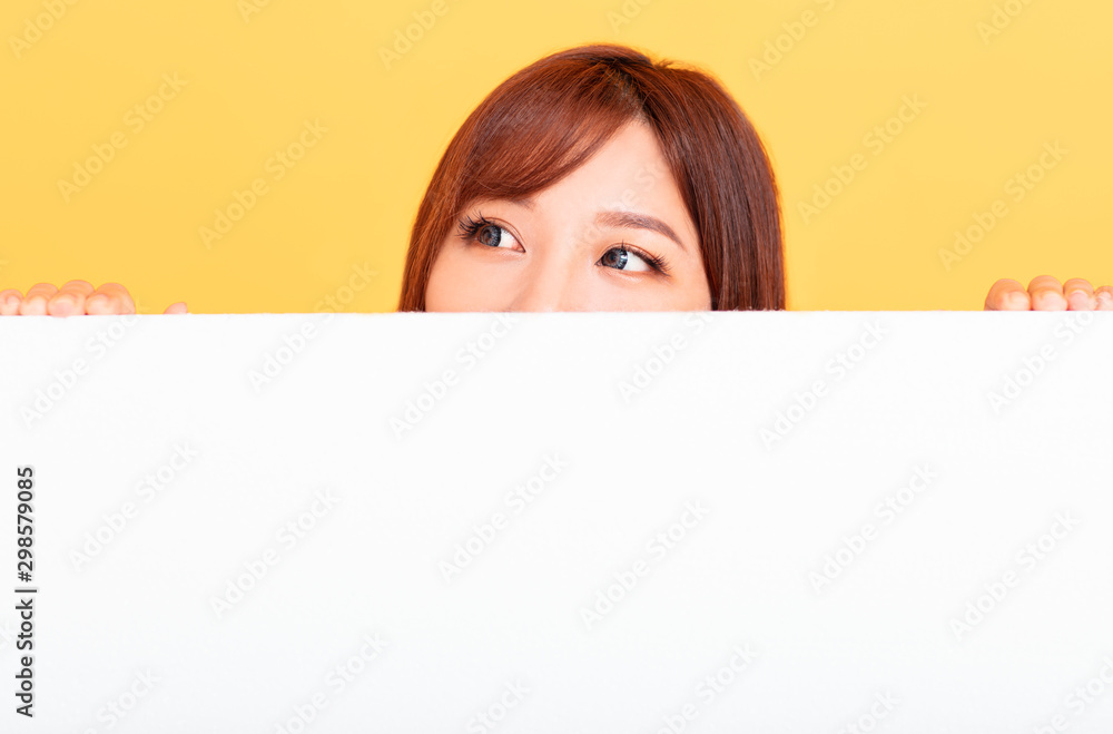 Young Asian woman holding blank billboard for advertising signs Young Asian woman holding blank billboard for advertising signs