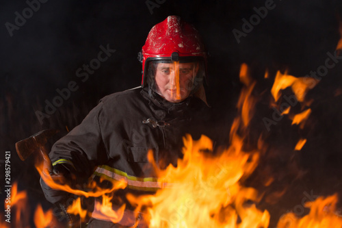 firefighter puts out a fire at night