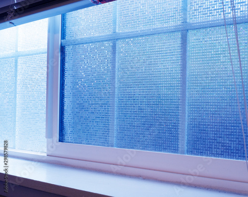 Window in a house with textured privacy film 