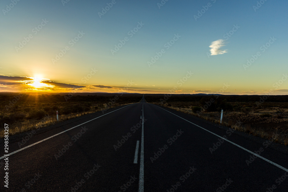 straight road through the nullarbor dessert of Australia at sunset, South Australia, Australia