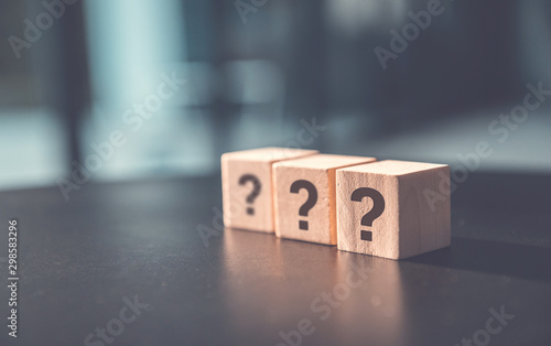 ? Questions Mark word in wooden cube block on table background. FAQ  Answer, Q&A. photo
