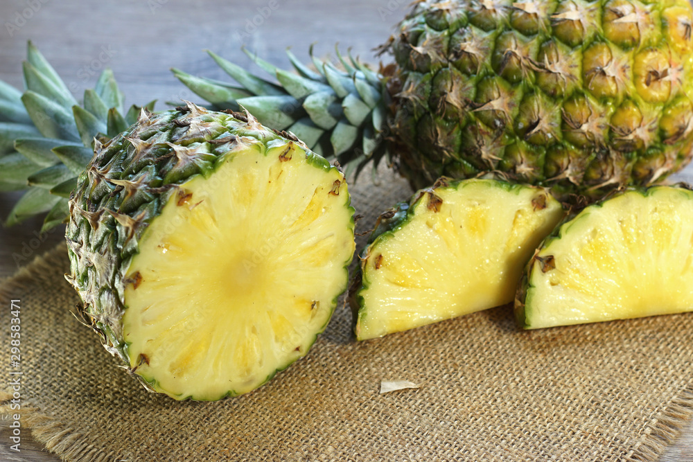 slices of pineapple on burlap served on table top slices of pineapple on burlap served on table top