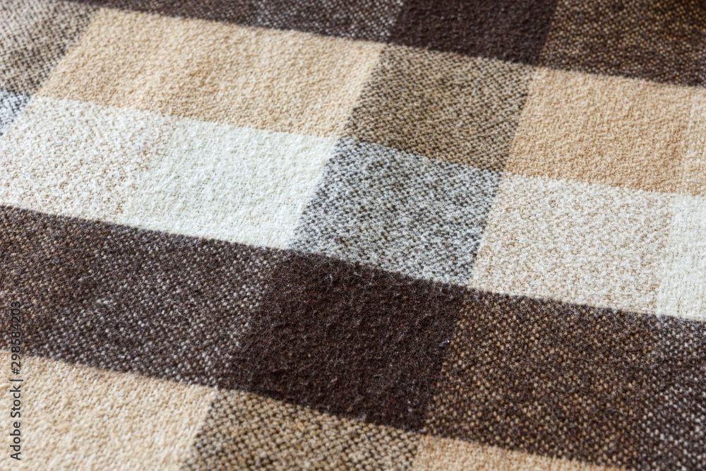 Fototapeta premium Brown checkered wool plaid fabric texture. tartan texture