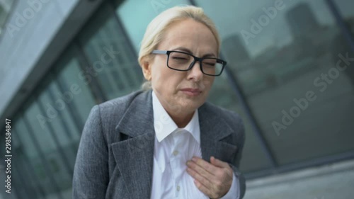 Lady in business suit suffering sharp pain in breast area, heart attack symptom