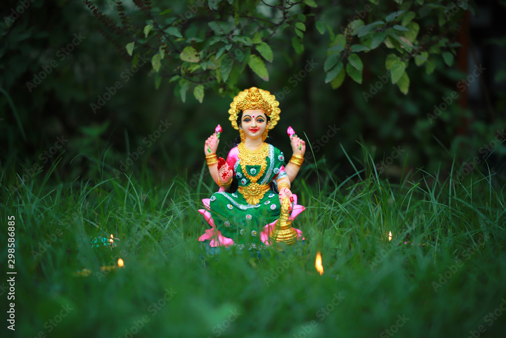 Naklejka premium Idol of Mahalakshmi, Diya and Tulsi on the auspicious occasion of Deepawali