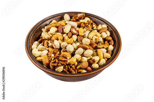 Bowl with mixed nuts isolated on white background. Walnuts, pistachio, almond, peanut, cashew, hazelnut in ceramic bowl