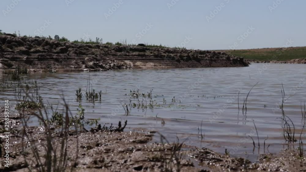 Low ground shot of rippling water in a stream bed, lock down shot. Low ground shot of rippling water in a stream bed, lock down shot.