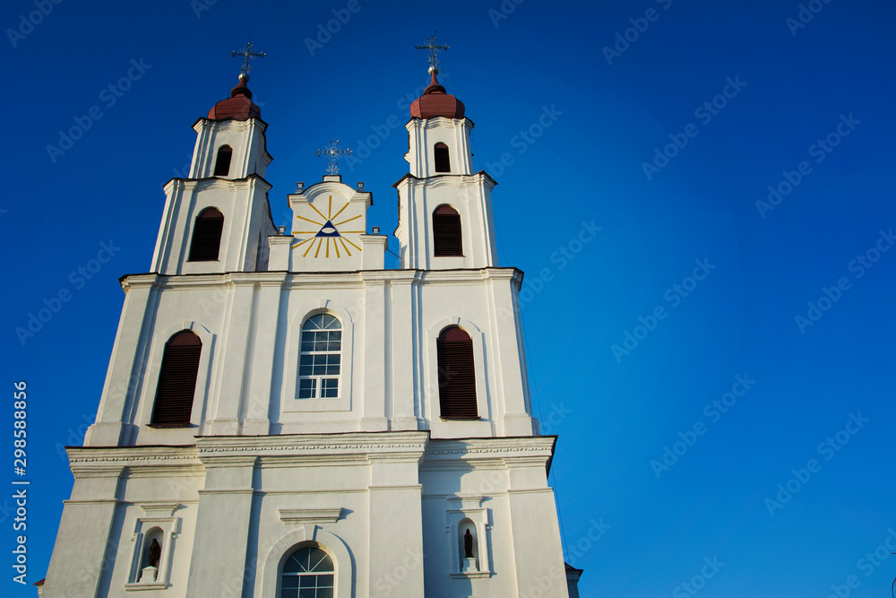 Catholic Cathedral Church with Catholic crosses on the background of blue clear cloudless sky.