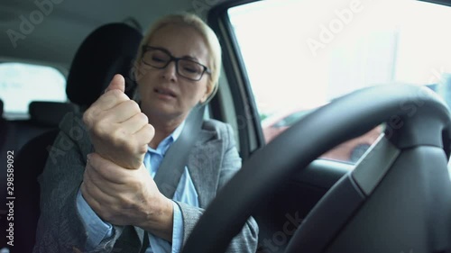Woman driver feeling pain in wrist holding steering wheel, spasm, arthritis