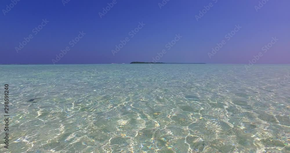 distant flat island in clear waters of malaysia distant flat island in clear waters of malaysia