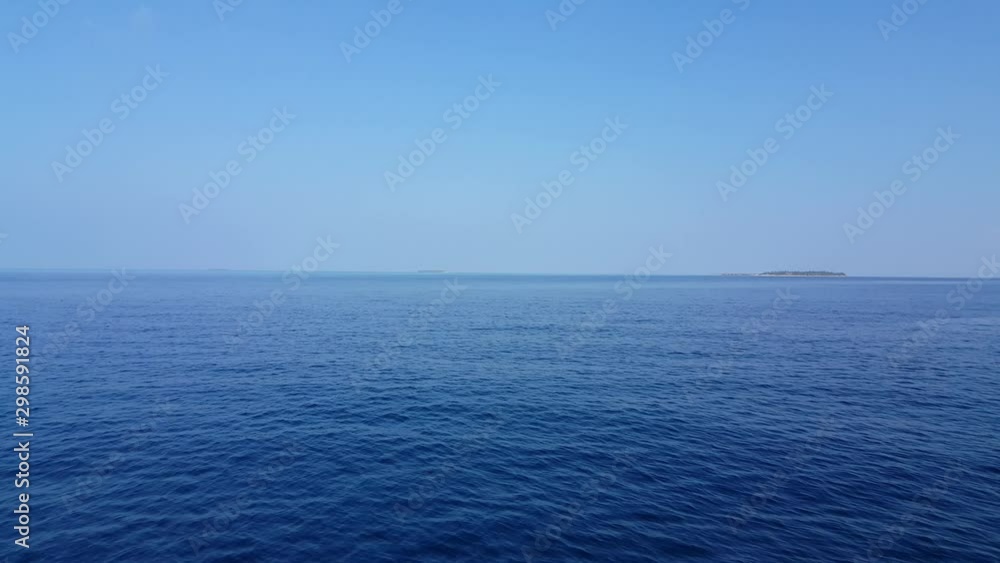 Distant view of Prison Changuu Island and turquoise clean water with clear blue sky - Wide shot
Distant view of Prison Changuu Island and turquoise clean water with clear blue sky - Wide shot