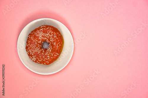 Beautiful juicy donut with a sweet cream..Cupcake on a pink background for kitchen design.