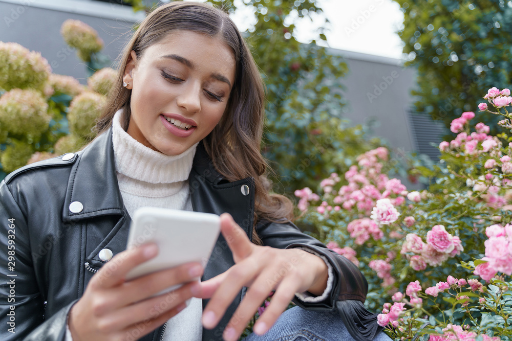 Happy girl reading her phone message history
