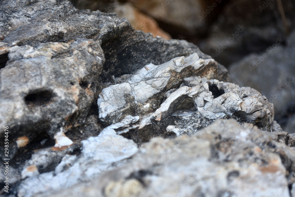 Beautiful texture of the light stone is photographed in close-up. Details of rock nature texture. A rocky ground surface. Beautiful texture of the light stone is photographed in close-up. Details of rock nature texture. A rocky ground surface.