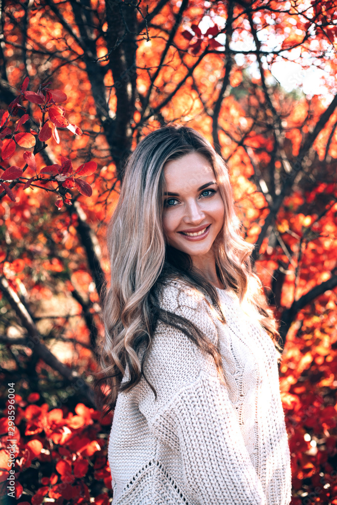 Beautiful smiling woman enjoying autumn in the forest. Beautiful smiling woman enjoying autumn in the forest.