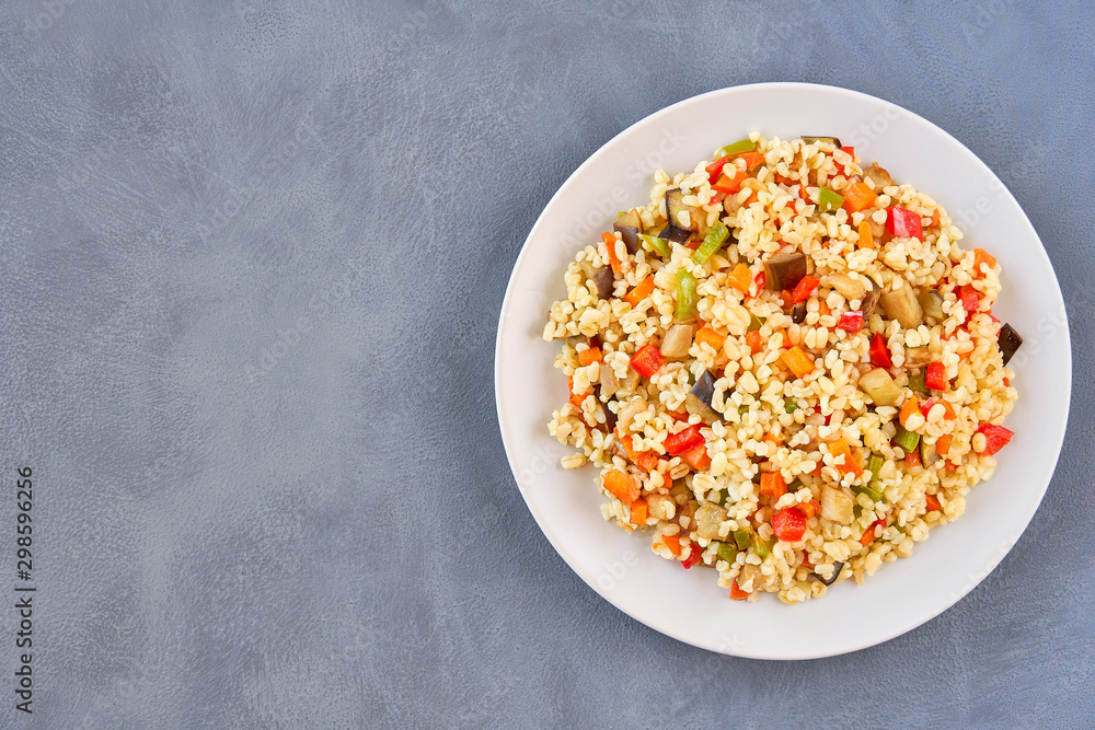 Bulgur pilaf with eggplant and vegetables. Top view with copy space Bulgur pilaf with eggplant and vegetables. Top view with copy space