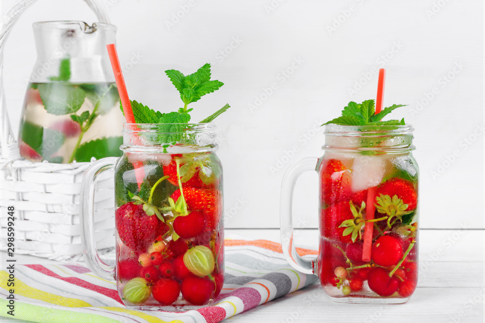 Two glasses with drink of fresh ripe berries on beautiful towel