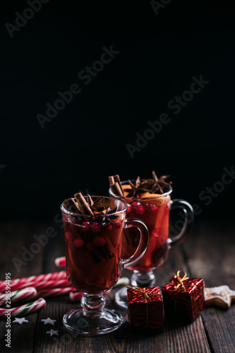 Christmas holidays atmosphere, cold winter day. Warming mood. Mulled wine with cranberry, cinnamon, orange and anise.