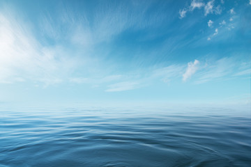 Blue sea or ocean with sunny and cloudy sky